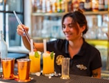 A bartender making cocktails in a bar.