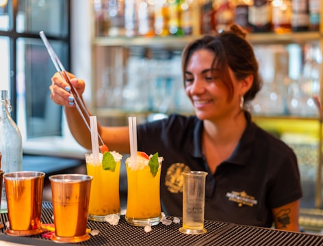 A bartender making cocktails in a bar.