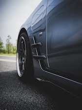 A close-up shot of a sleek, grey car.