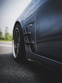 A close-up shot of a sleek, grey car.
