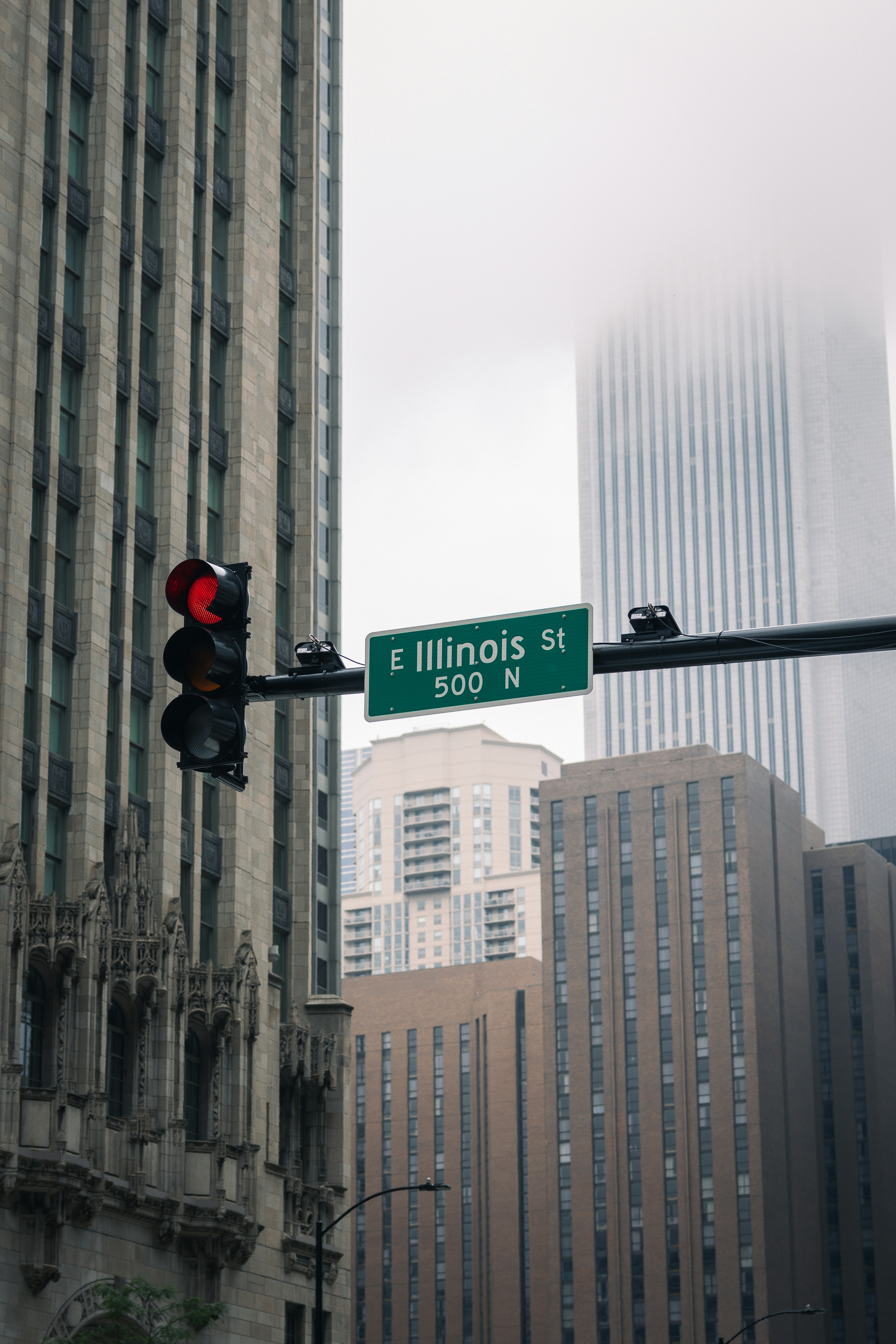 Traffic light on illinois street with city buildings.