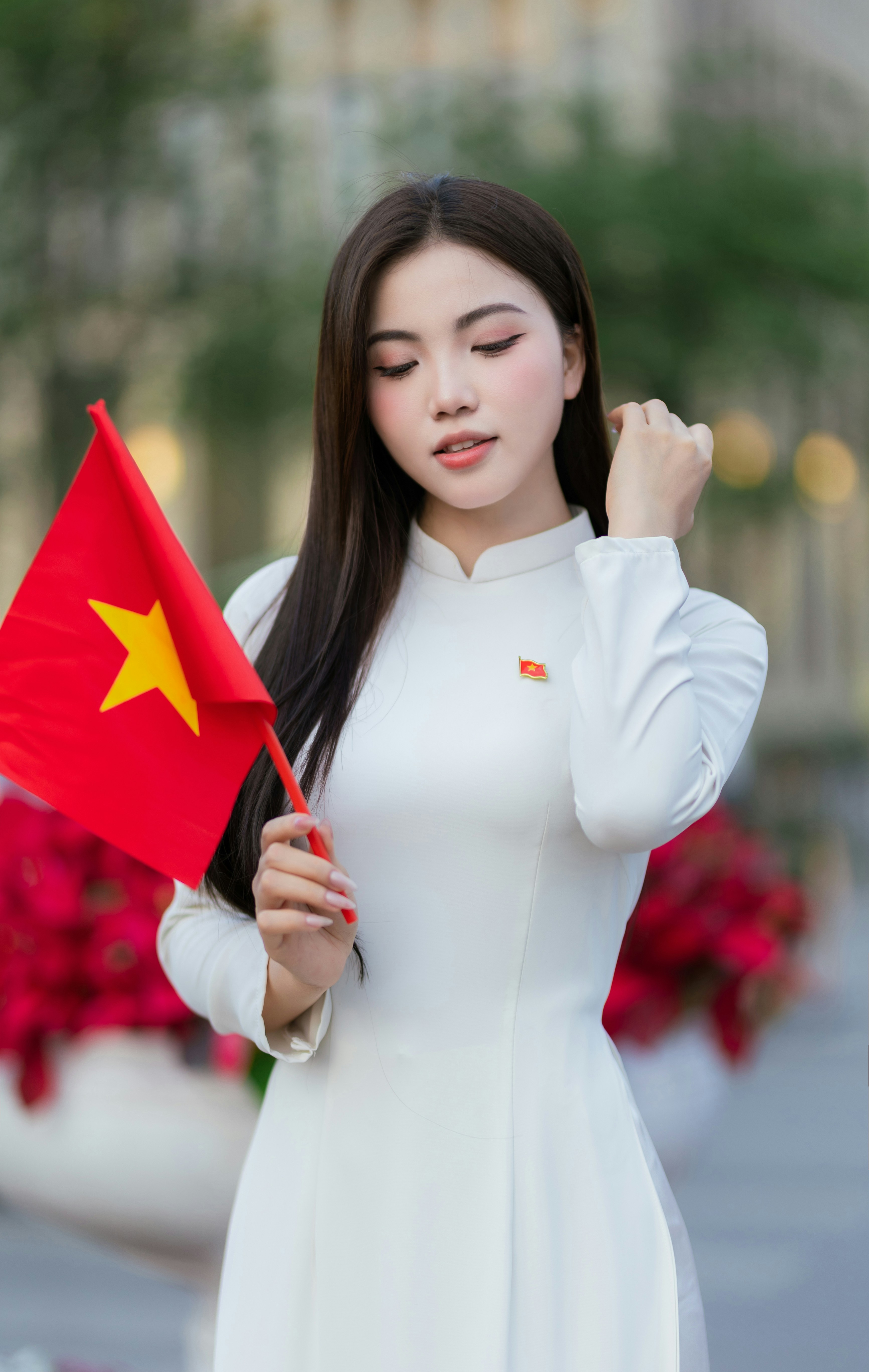 A woman holds the vietnamese flag proudly.