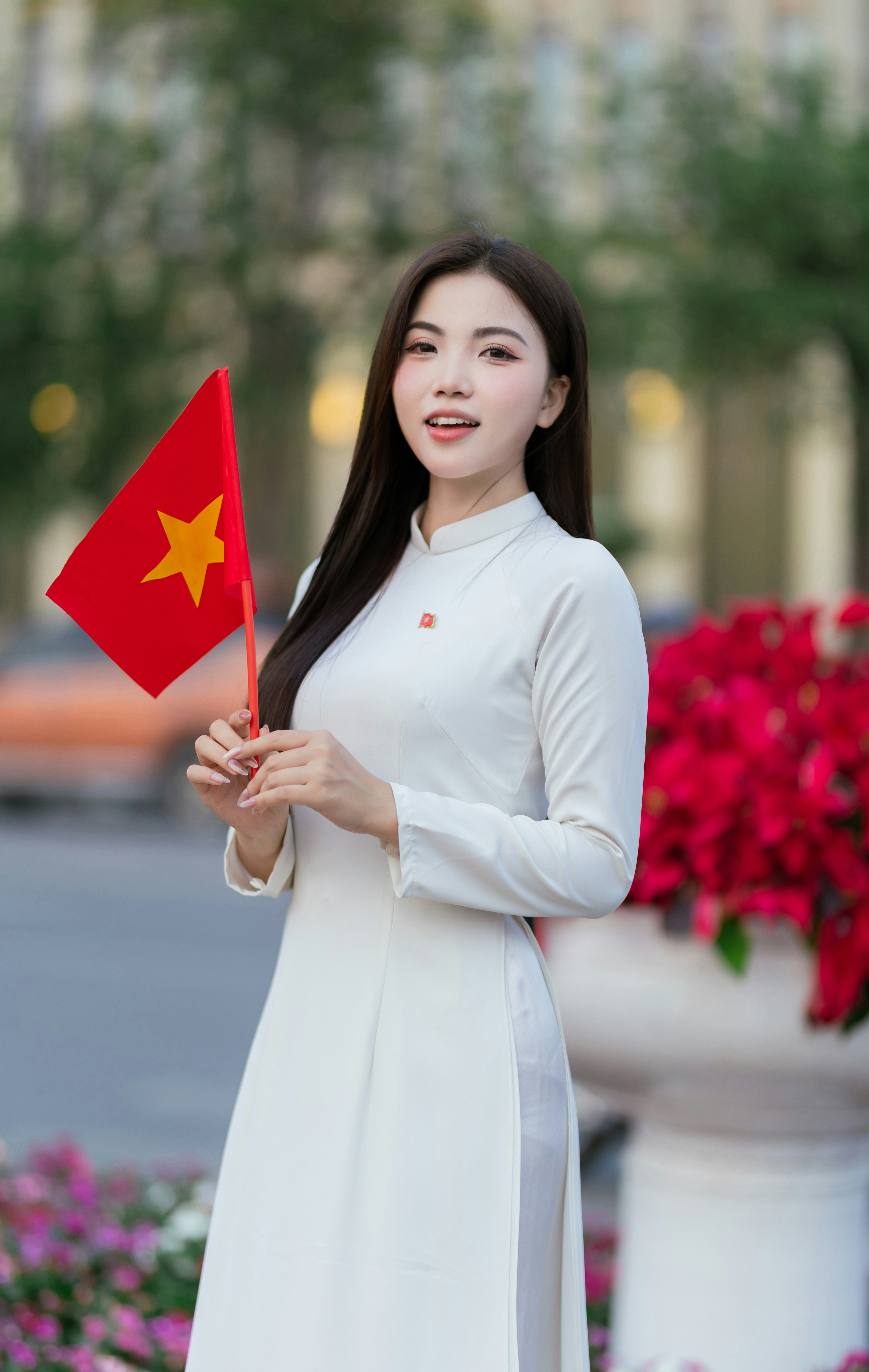 A woman holds the vietnamese flag.