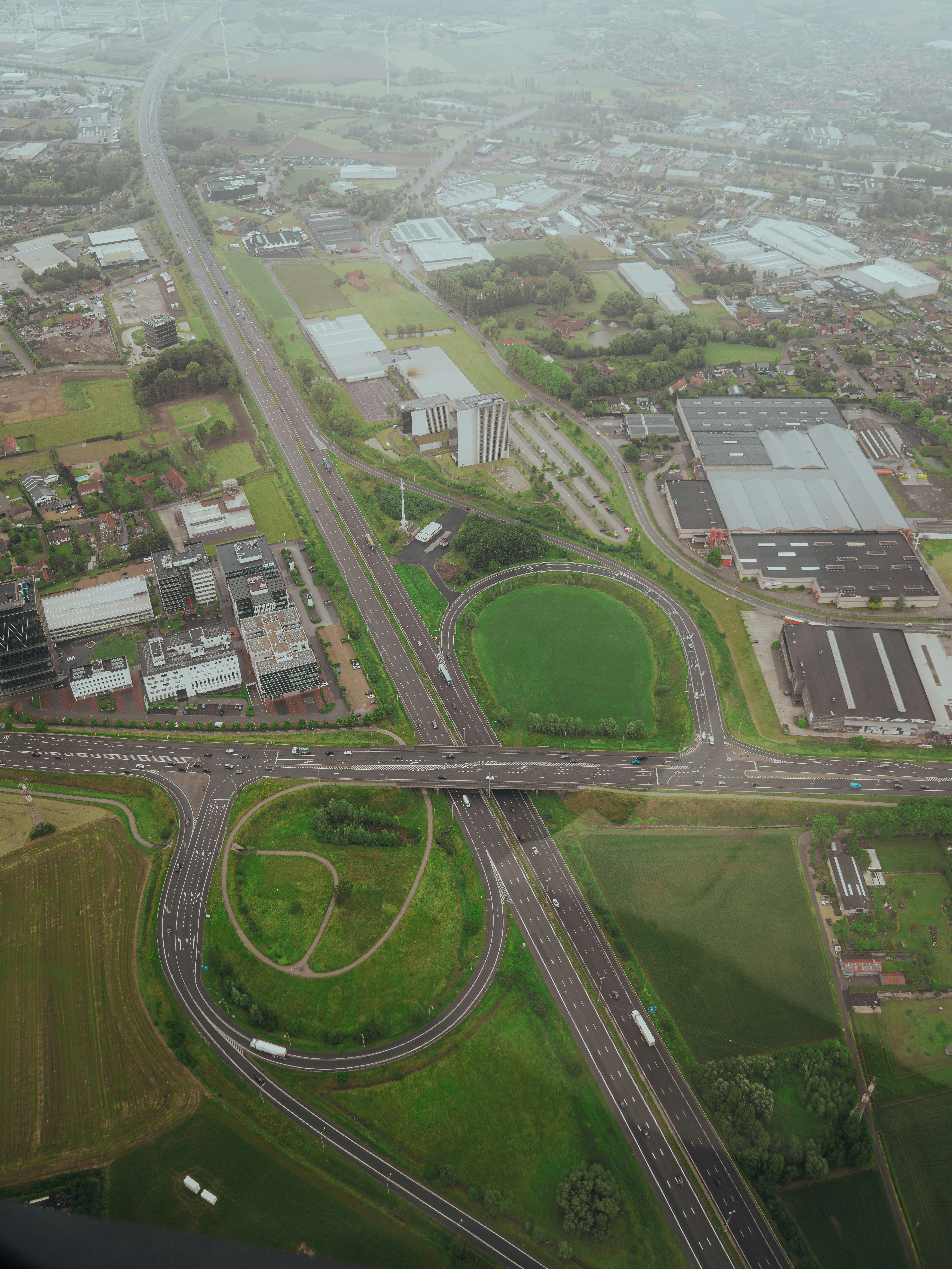 Aerial view of a highway with industrial buildings.