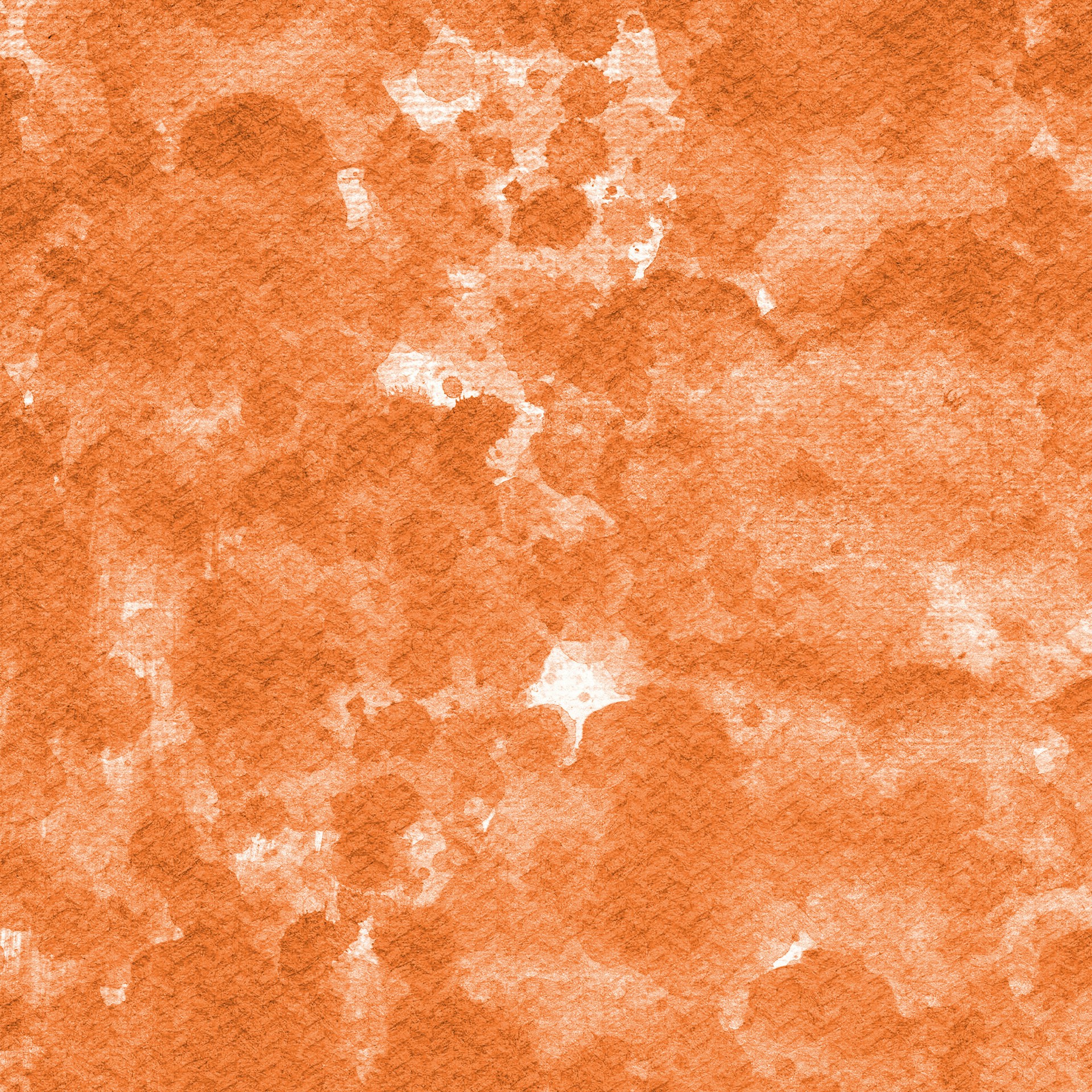 Orange watercolor paint on textured paper.