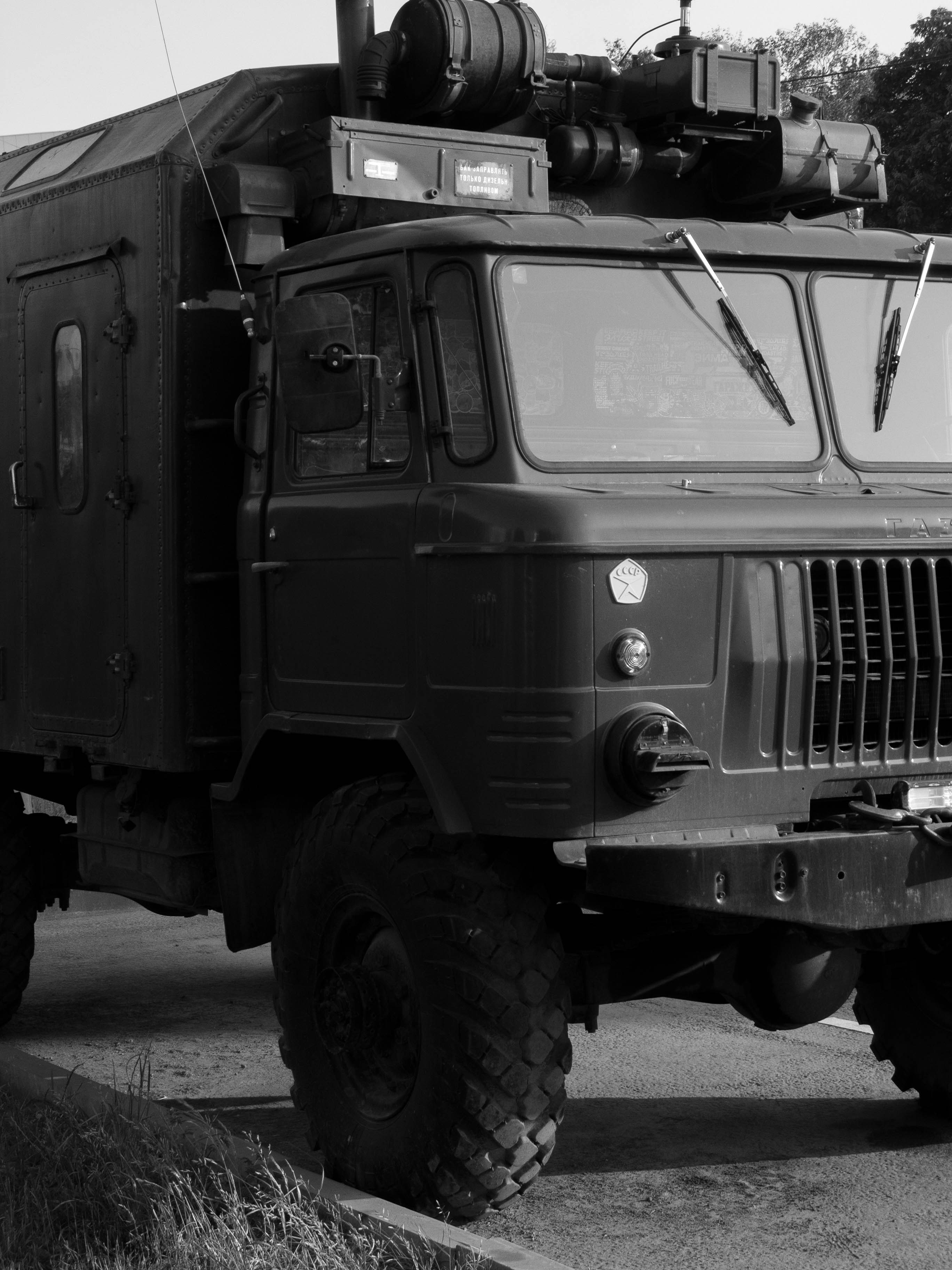 A military vehicle is shown in black and white.