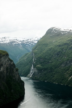 A scenic fjord surrounded by green mountains.