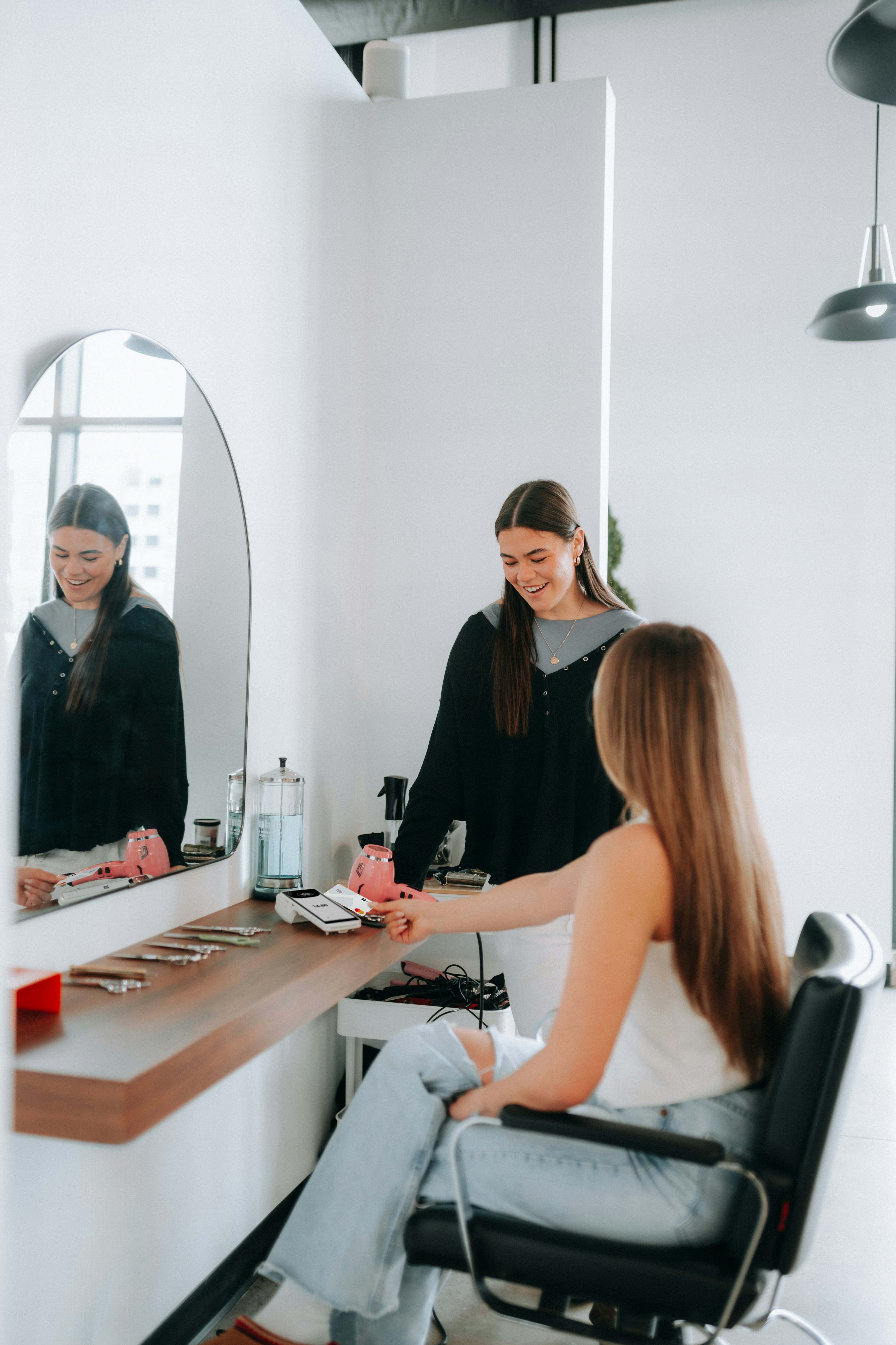 client paying for extensions at a salon