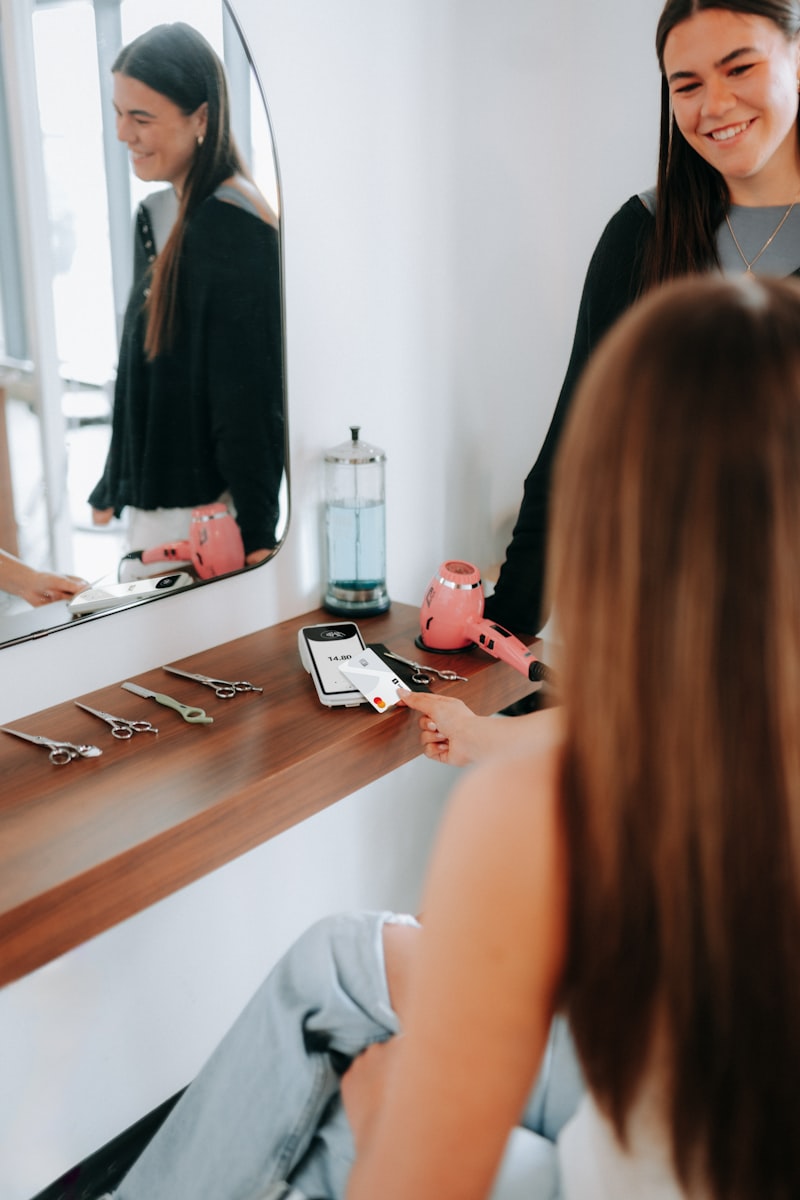 A customer pays at a hair salon using a card terminal
