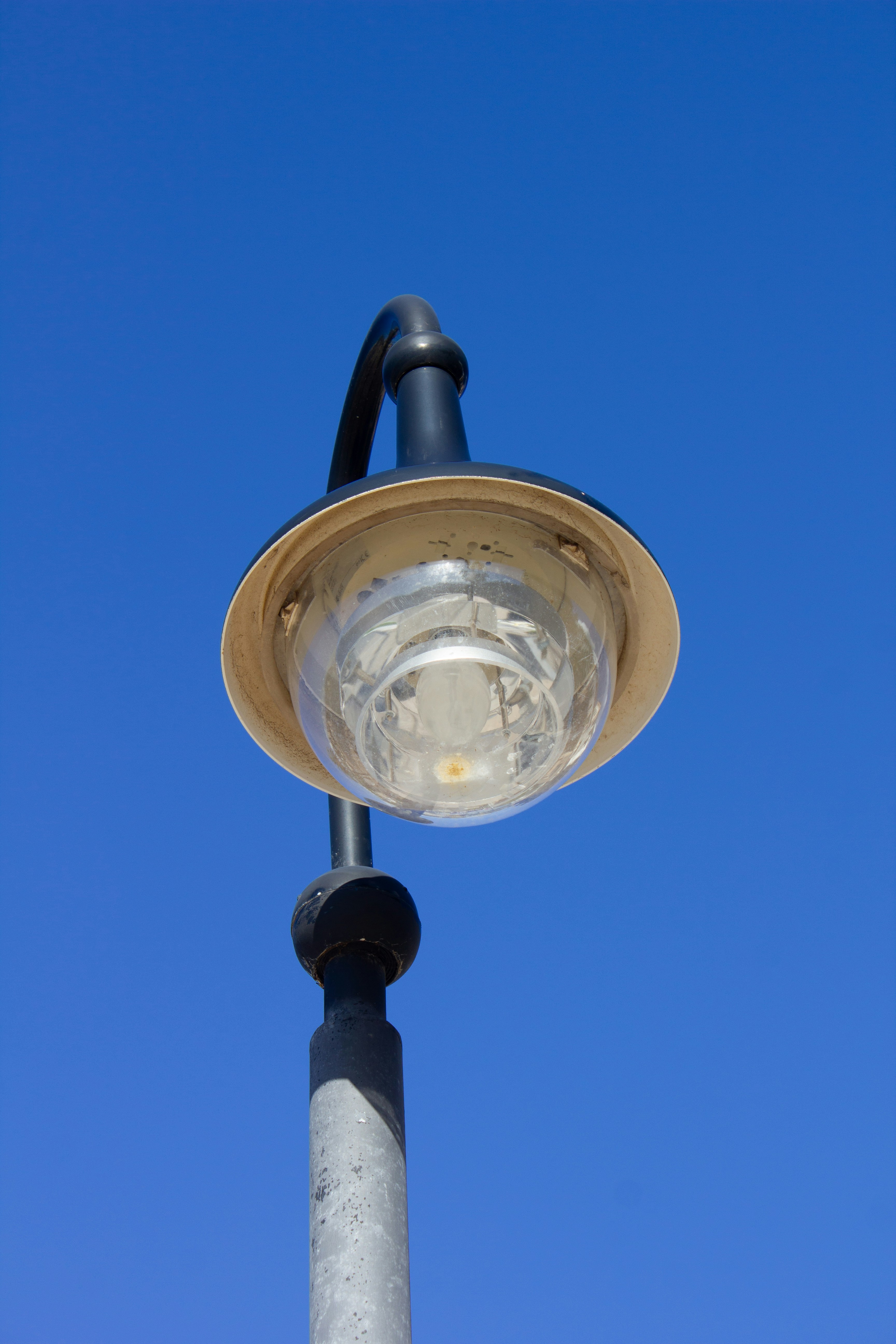 A street lamp against a blue sky.