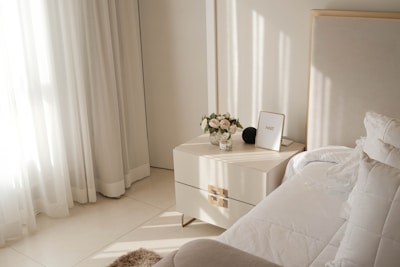 A bright, minimalist bedroom with soft lighting.