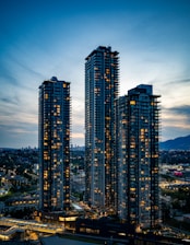 Skyscrapers illuminate the night sky in the city.