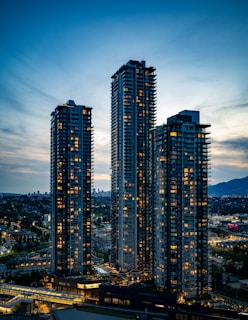 Skyscrapers illuminate the night sky in the city.