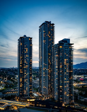Skyscrapers illuminate the night sky in the city.