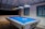 A blue pool table is ready for play.