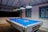 A blue pool table is ready for play.