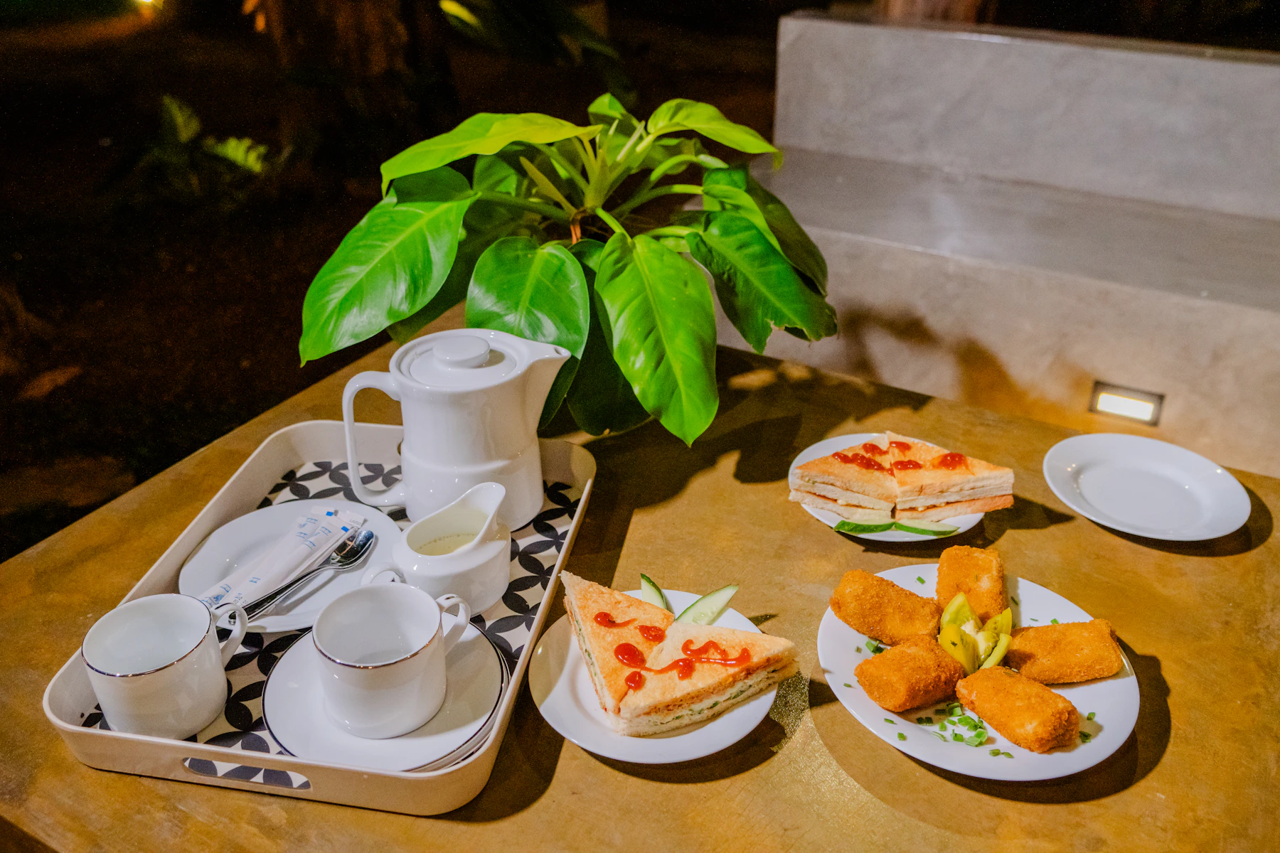 Tea and savory snacks arranged on a table for a relaxed shared food moment