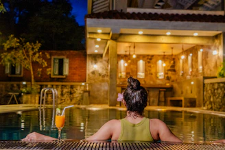 Woman enjoys a relaxing evening in the pool.