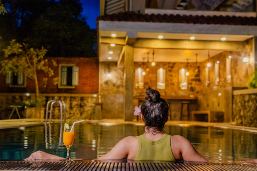 Woman enjoys a relaxing evening in the pool.