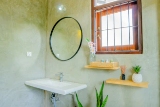 A stylish bathroom with a window and decor.