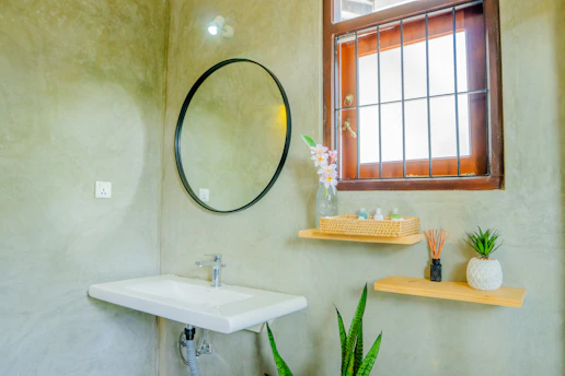 A stylish bathroom with a window and decor.