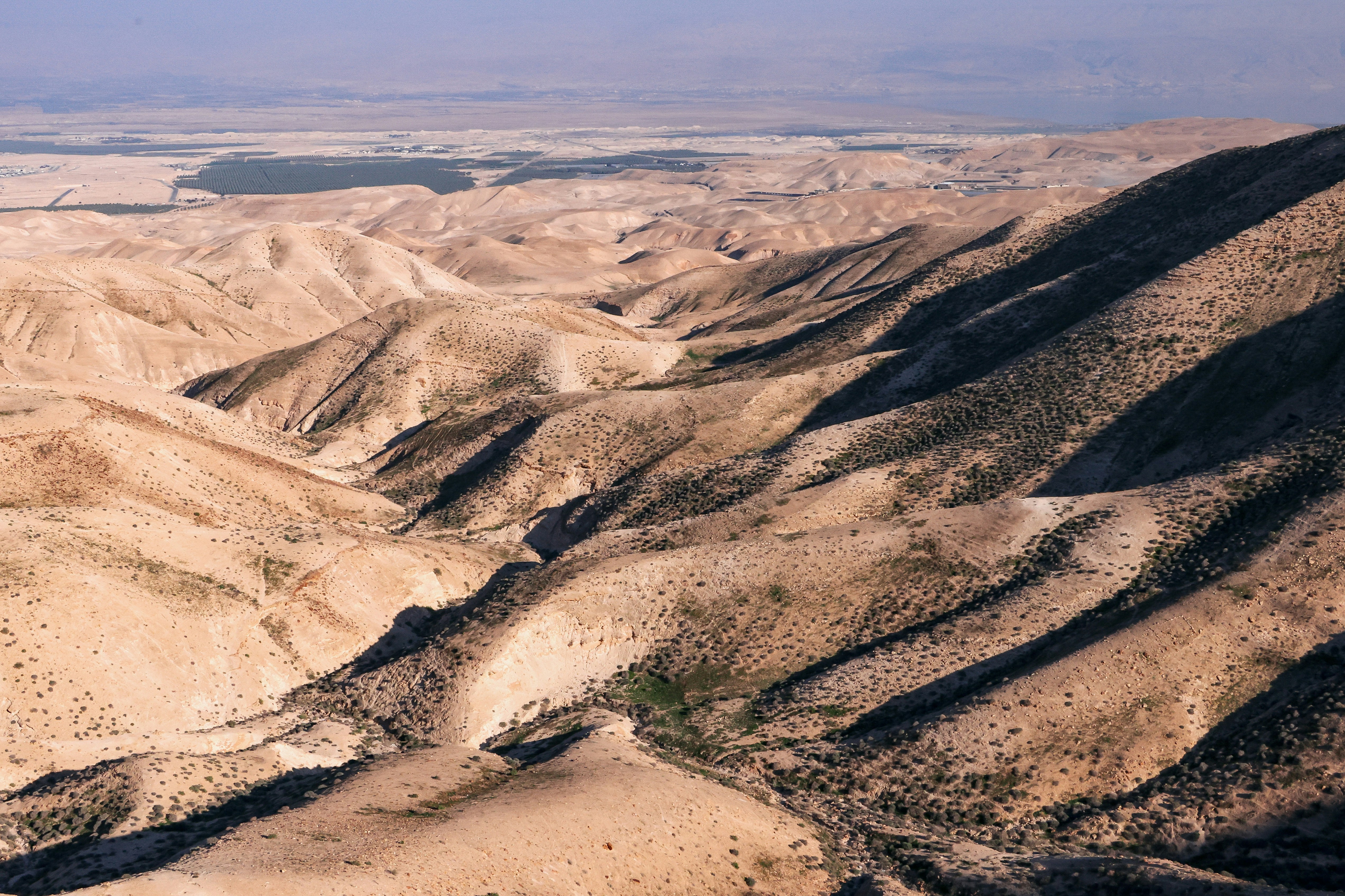 Rolling hills and a vast, arid landscape.