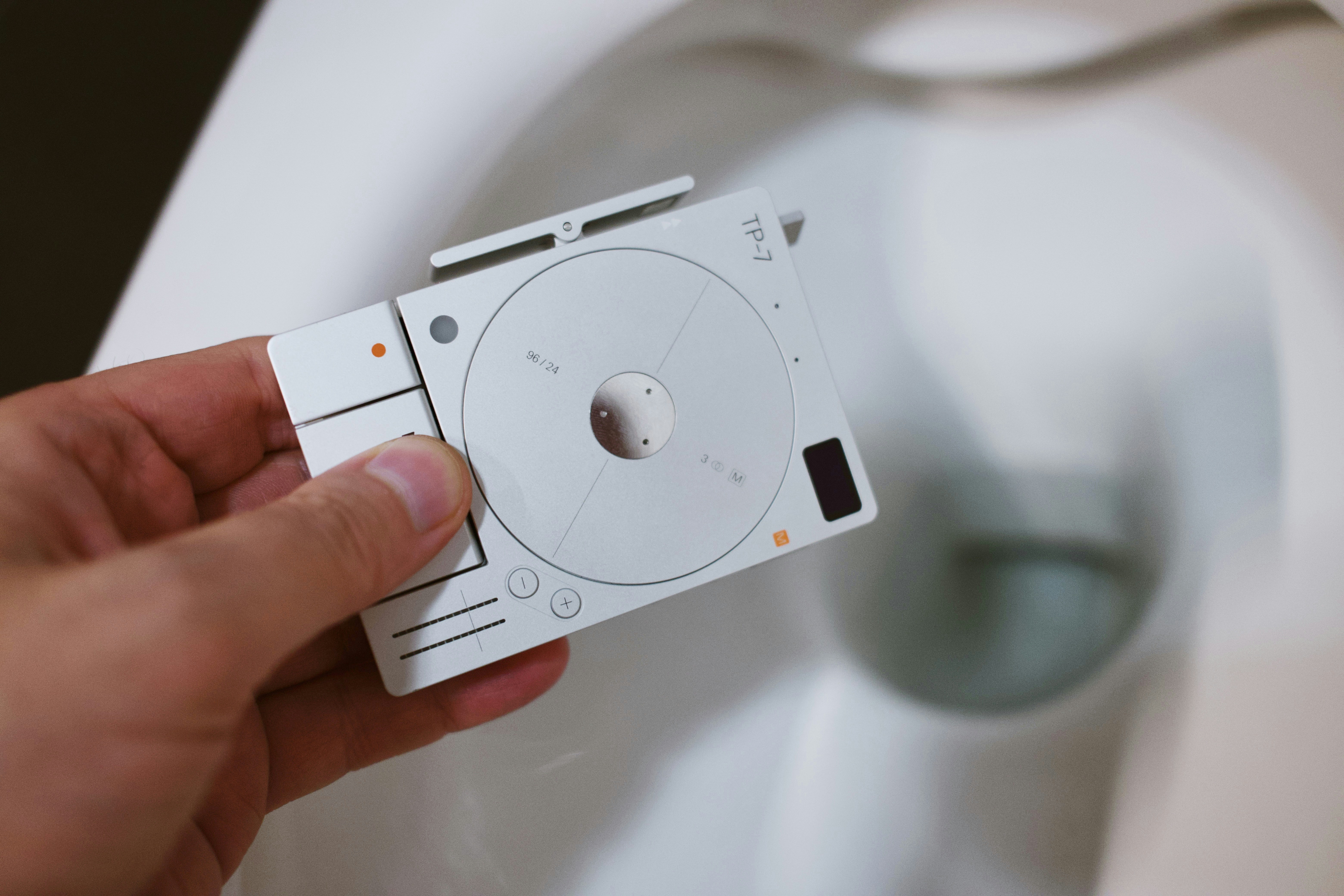 Hand holds a controller above the toilet.