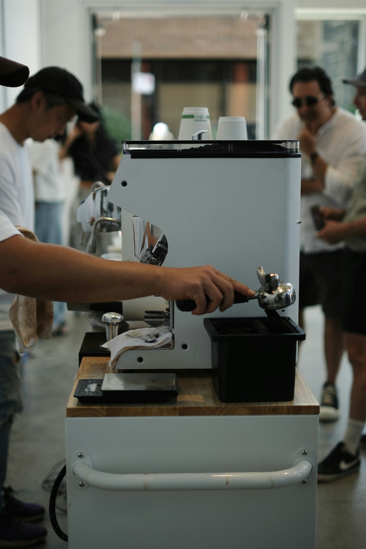 A home barista pulling an espresso shot on a semi-automatic machine — demonstrating hands-on technique