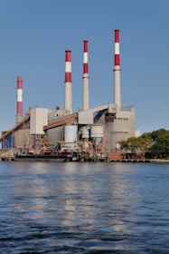 Power plant with chimneys against a blue sky.
