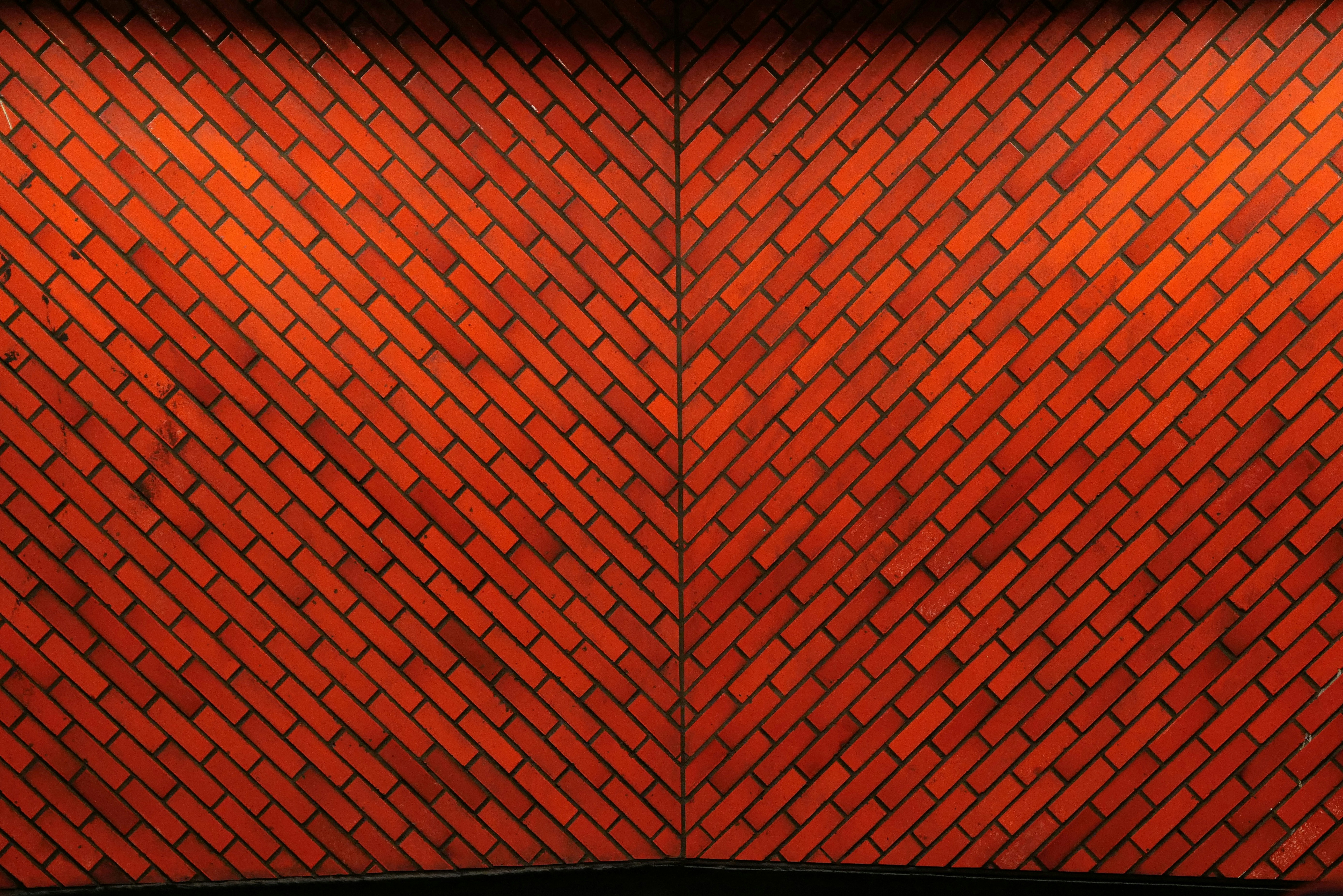 Diagonal brick walls meet in the middle.