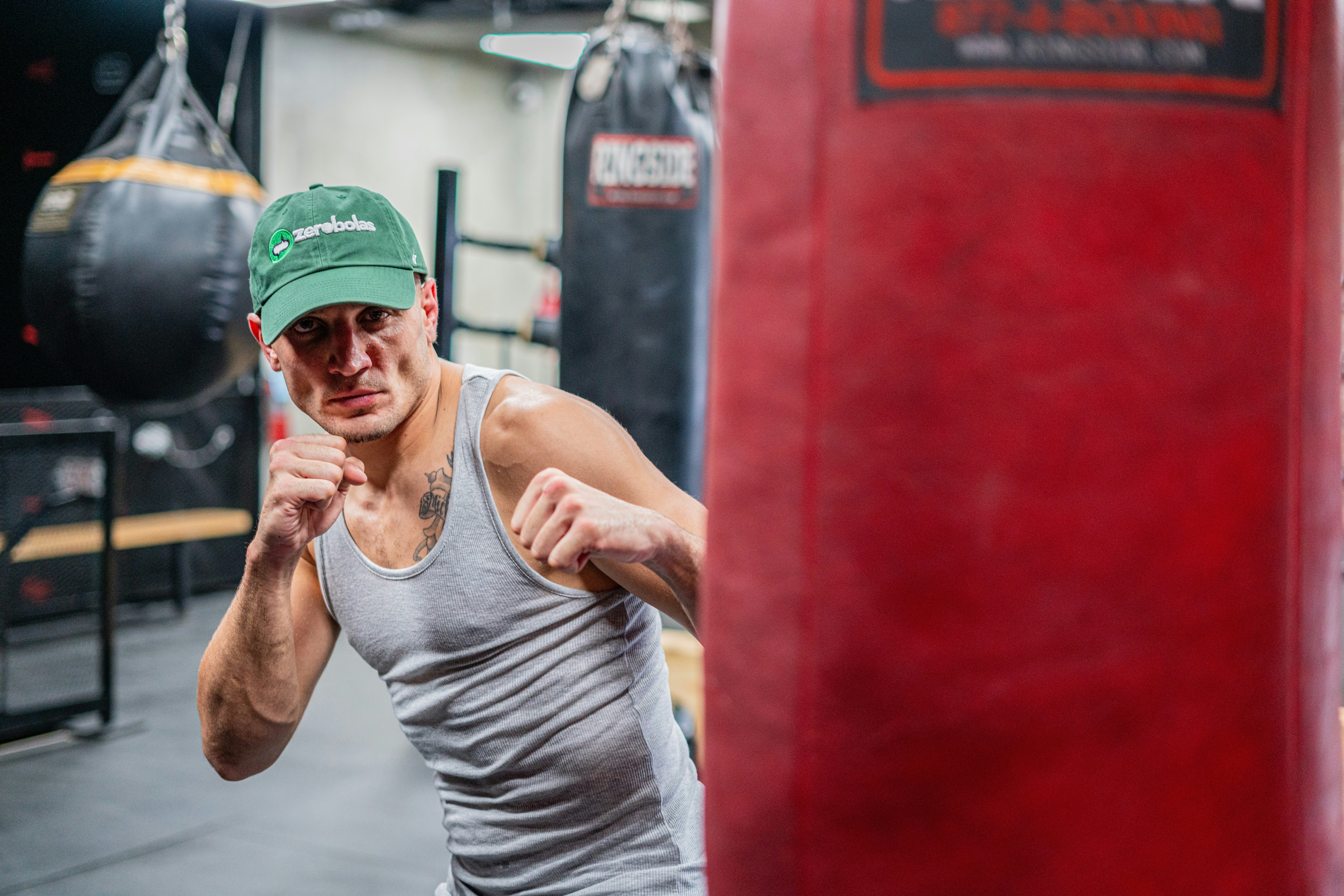 Boxer in the gym, practicing on the punching bag.