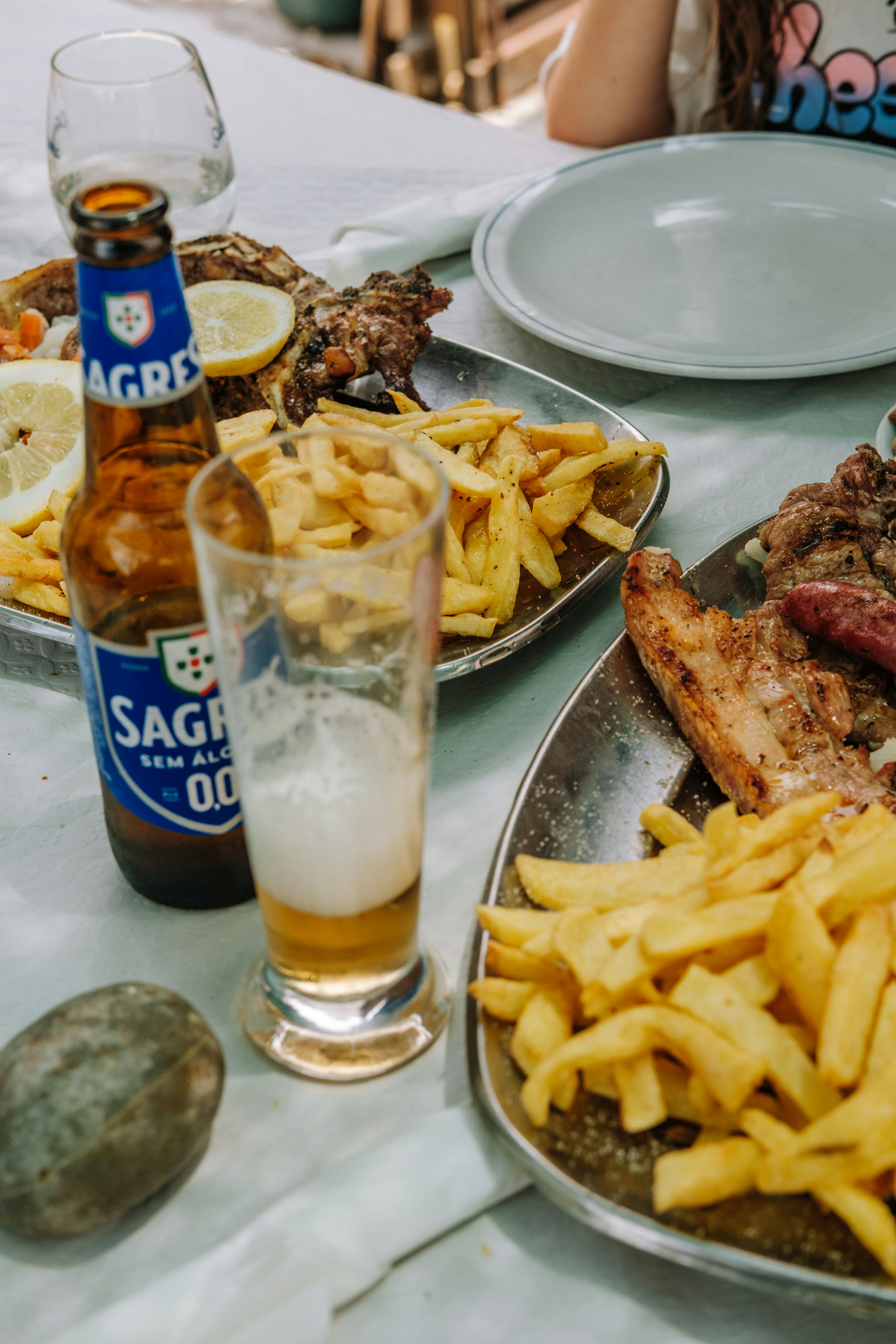 Grilled food and beer await a meal.