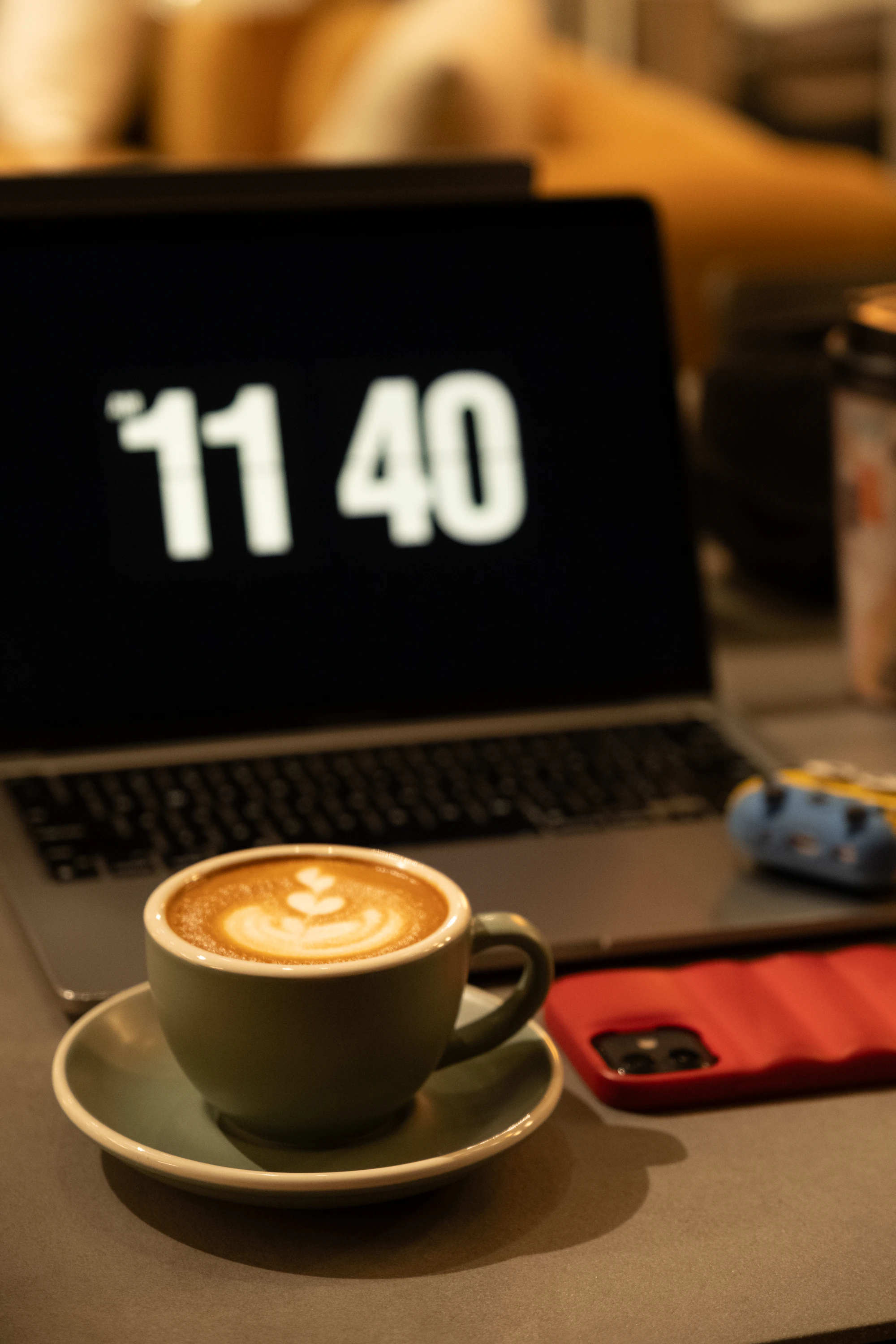 Creator working at a laptop with notes and a mug of coffee nearby