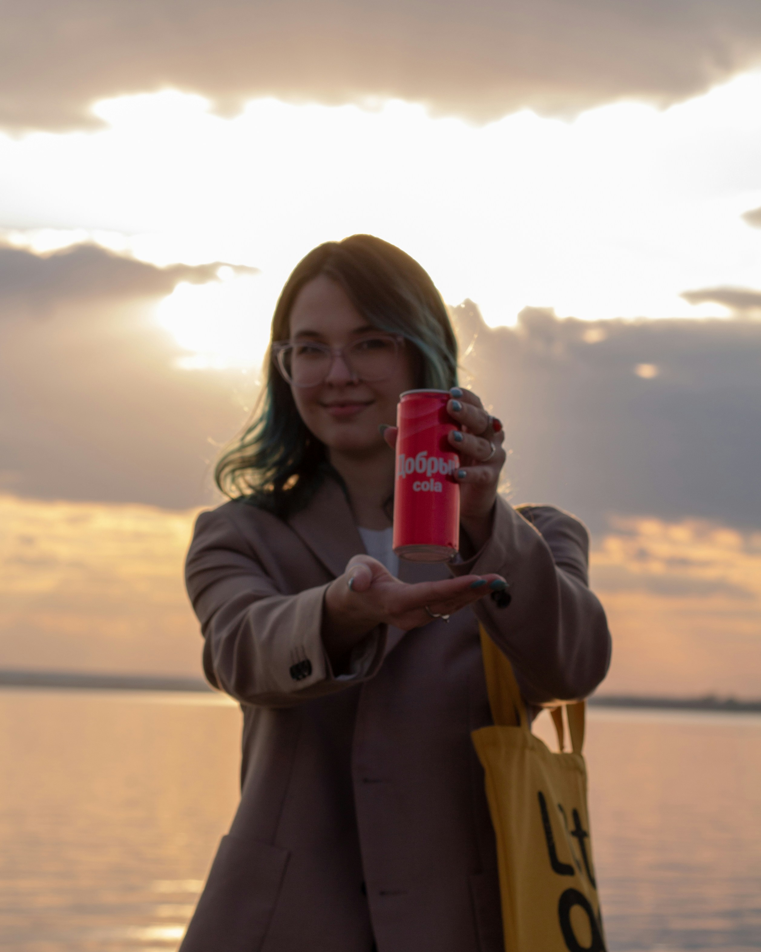 Woman holding a pink can with a yellow bag