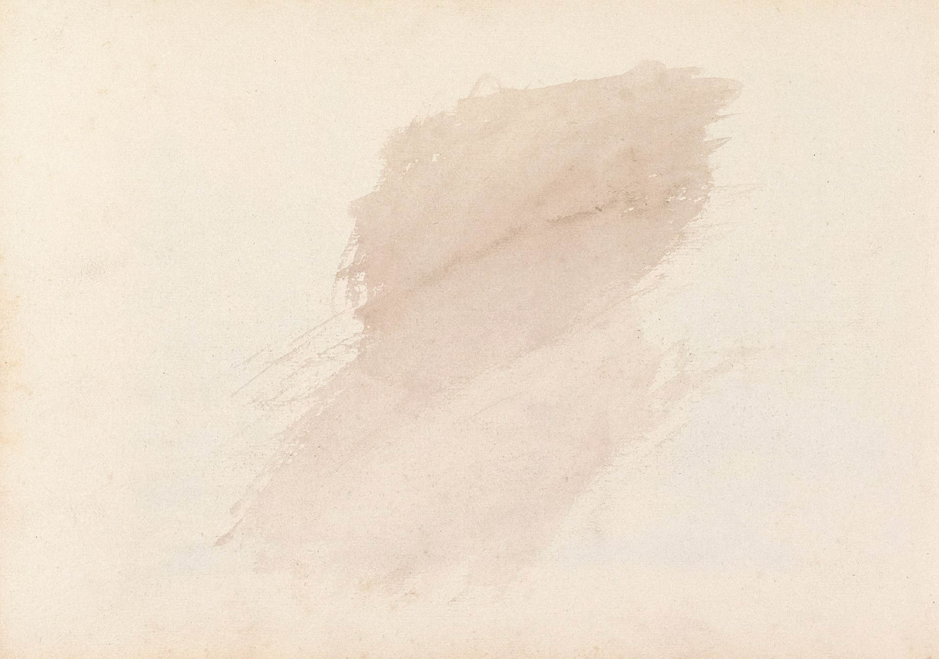 An abstract stain on a pale beige background.