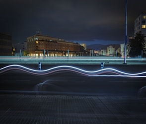 City lights streak across a night sky.