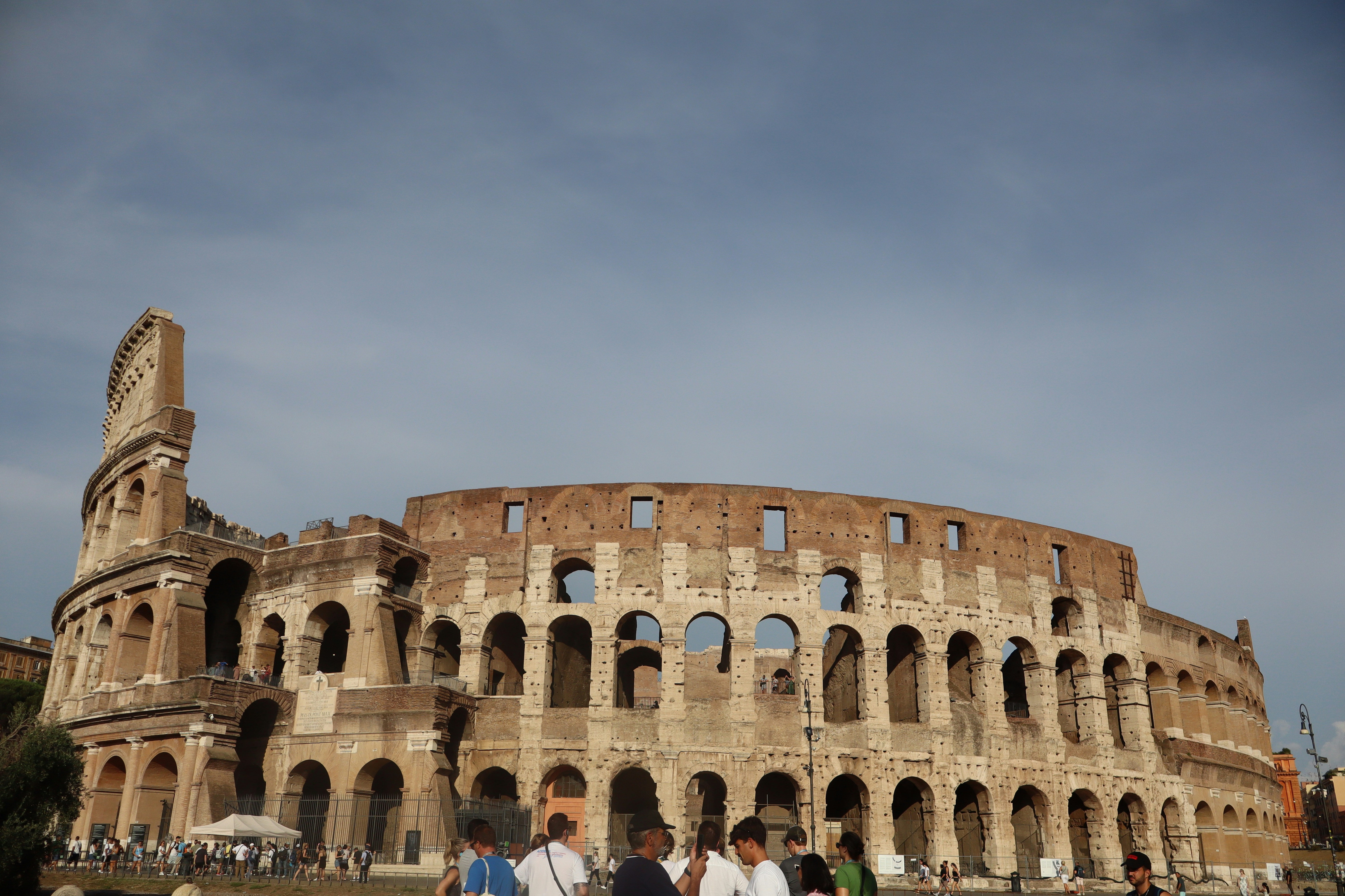 The colosseum stands tall against the sky.