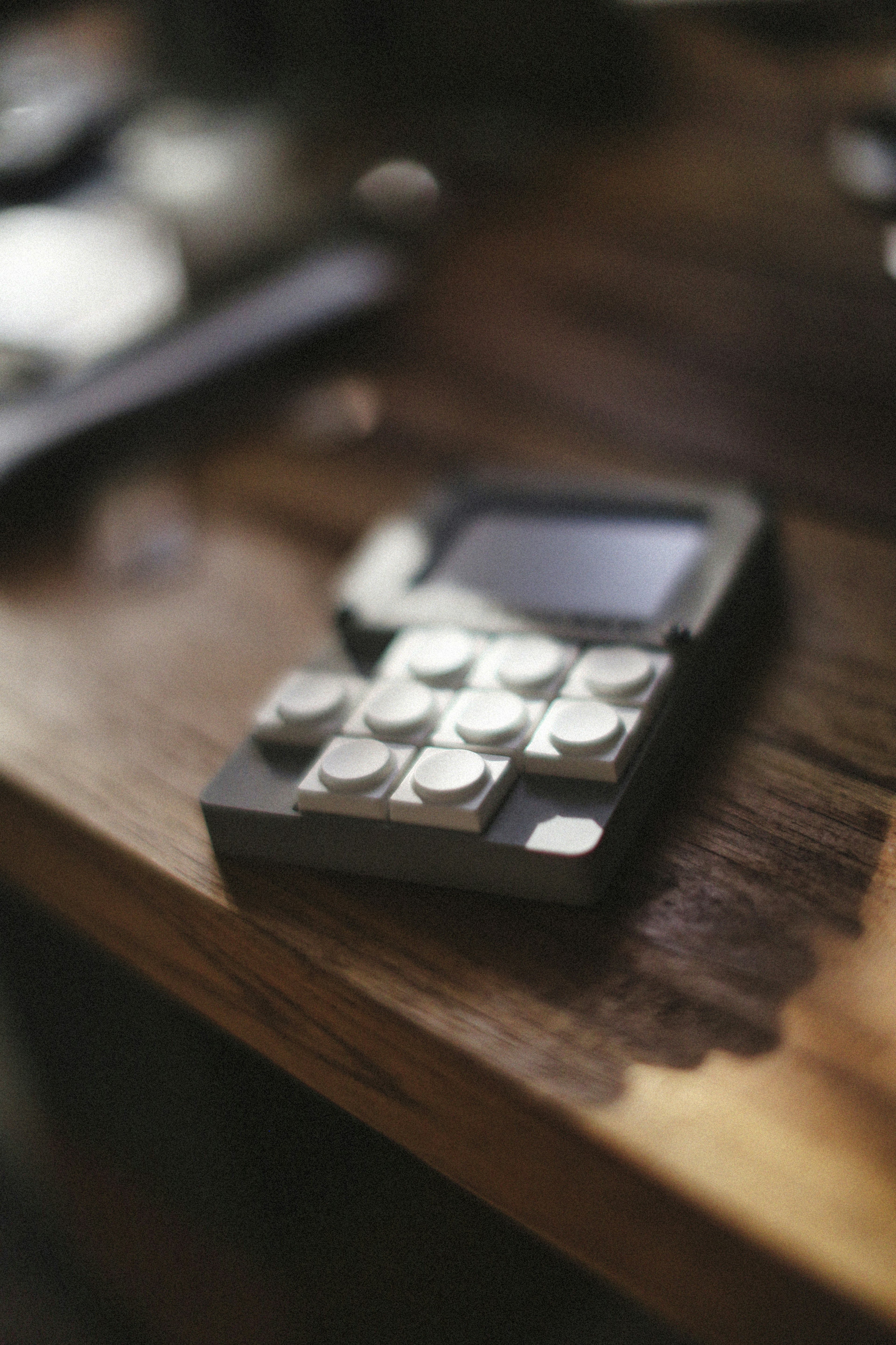 A unique phone sits on a wooden surface.