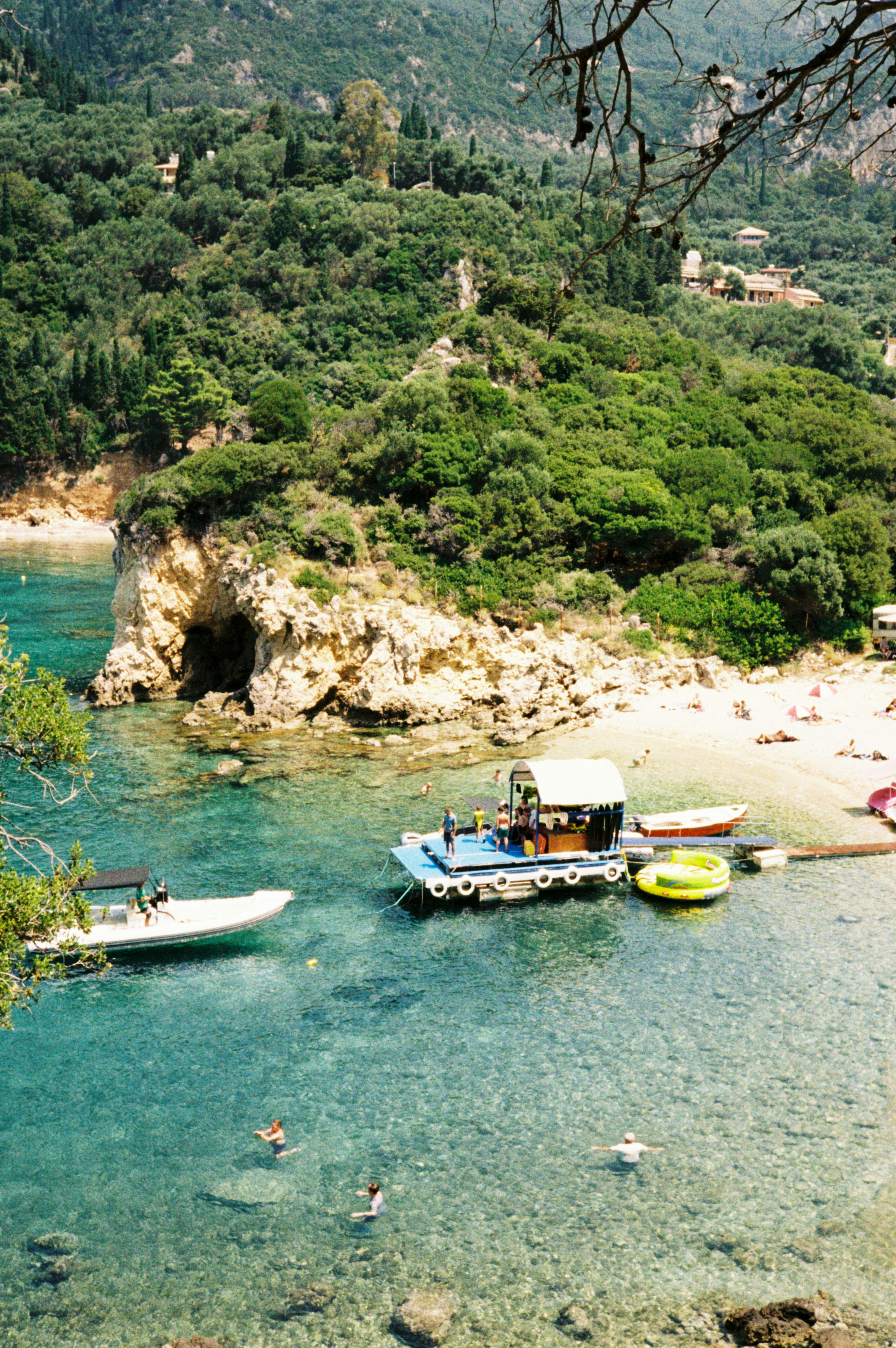 Boats float in a beautiful, clear ocean.