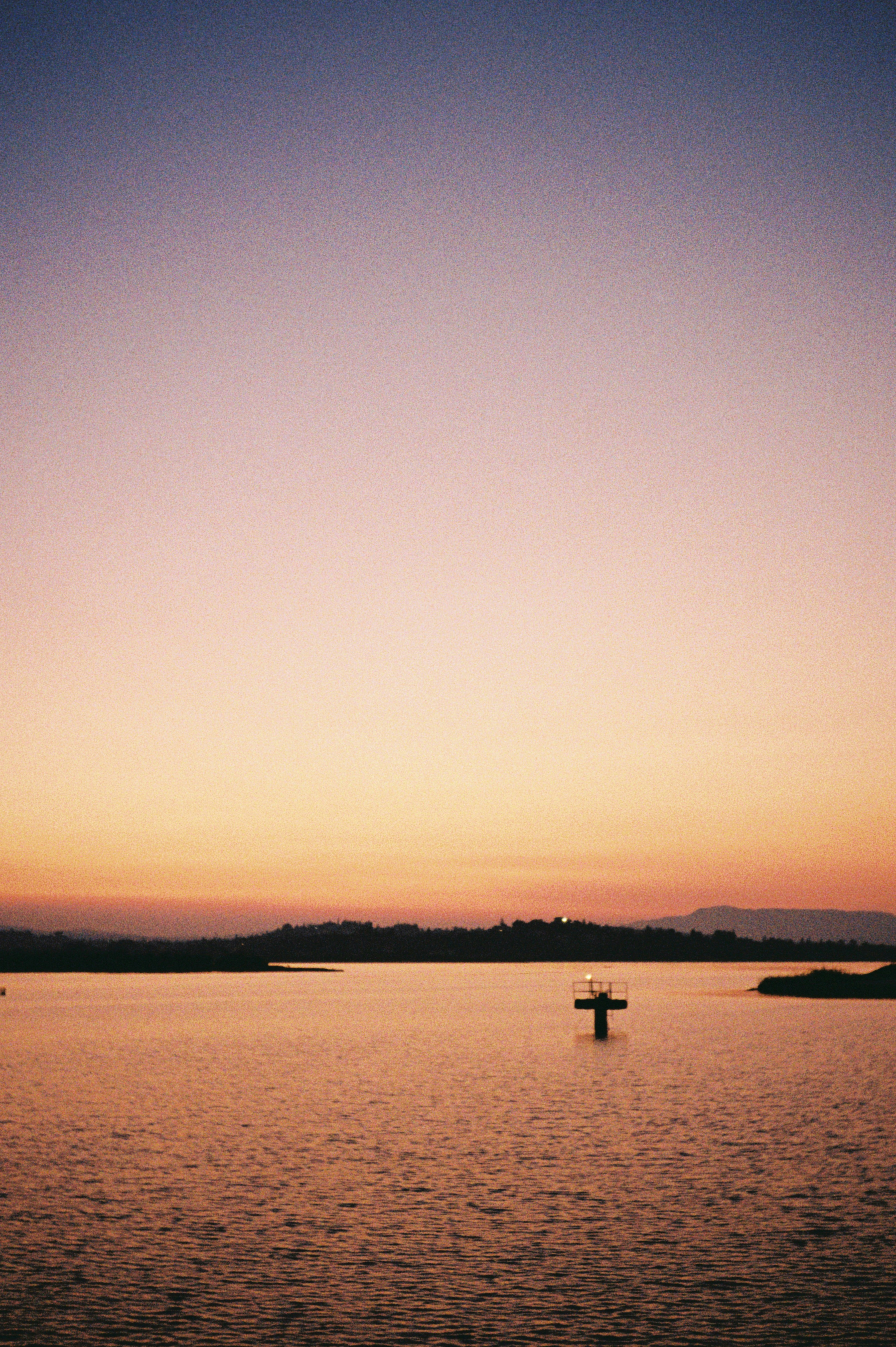 Sunset colors paint the water and sky.