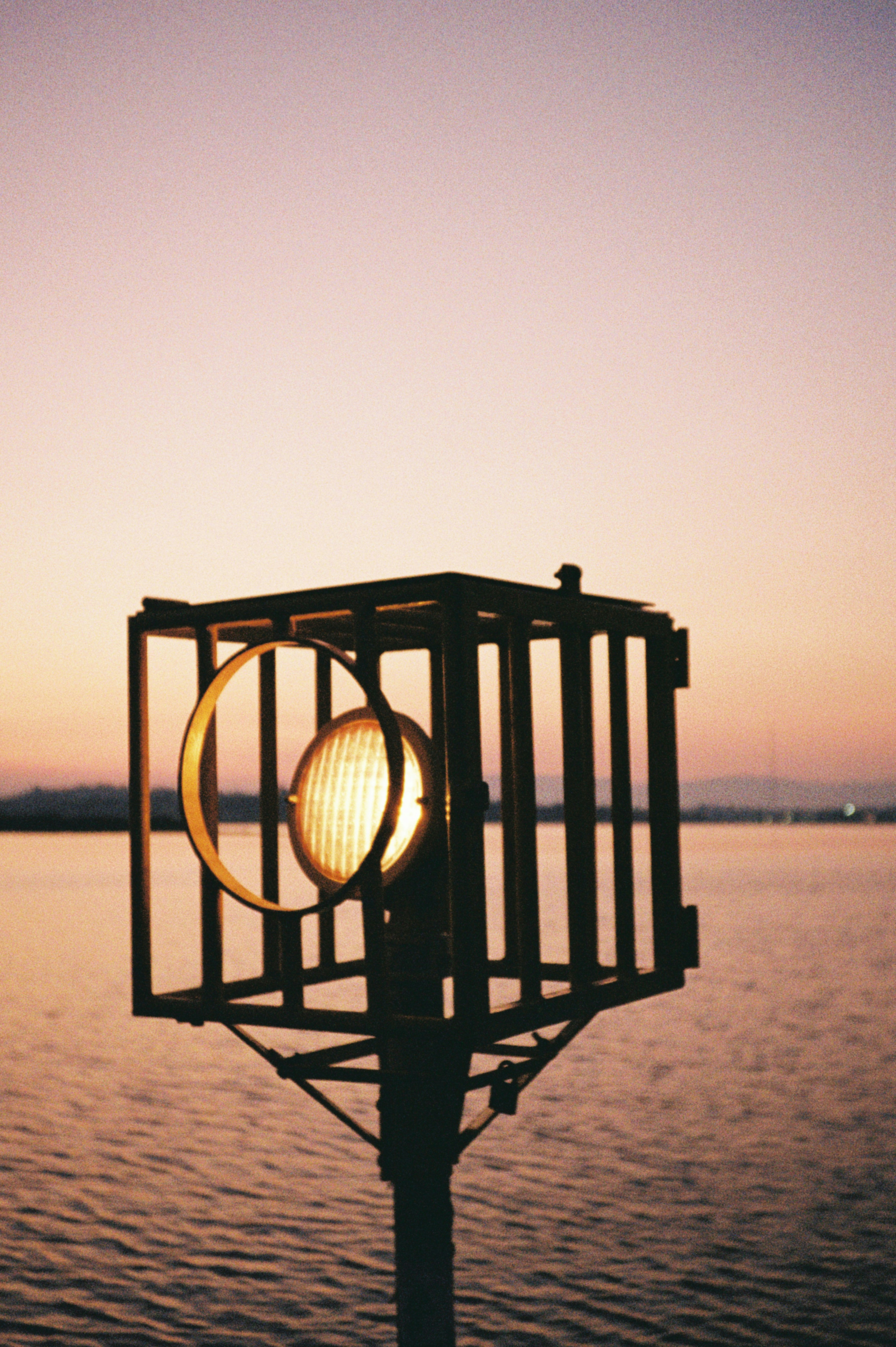 A light illuminates against the sunset.