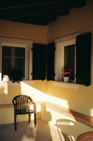 A sunny corner with windows and shutters.