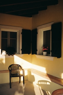A sunny corner with windows and shutters.