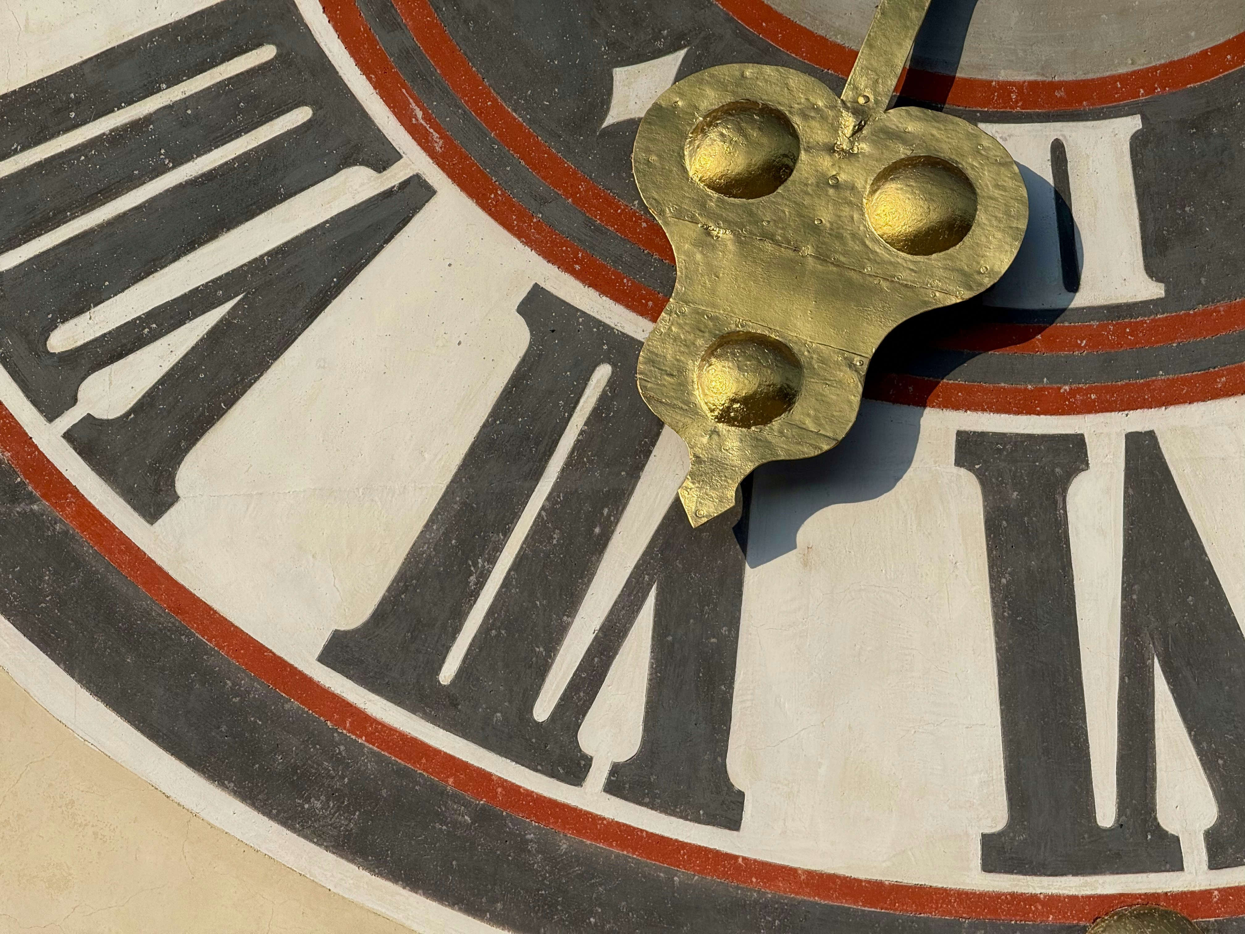 The clock's hands show the roman numerals.
