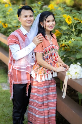 A happy couple poses for a wedding photo.