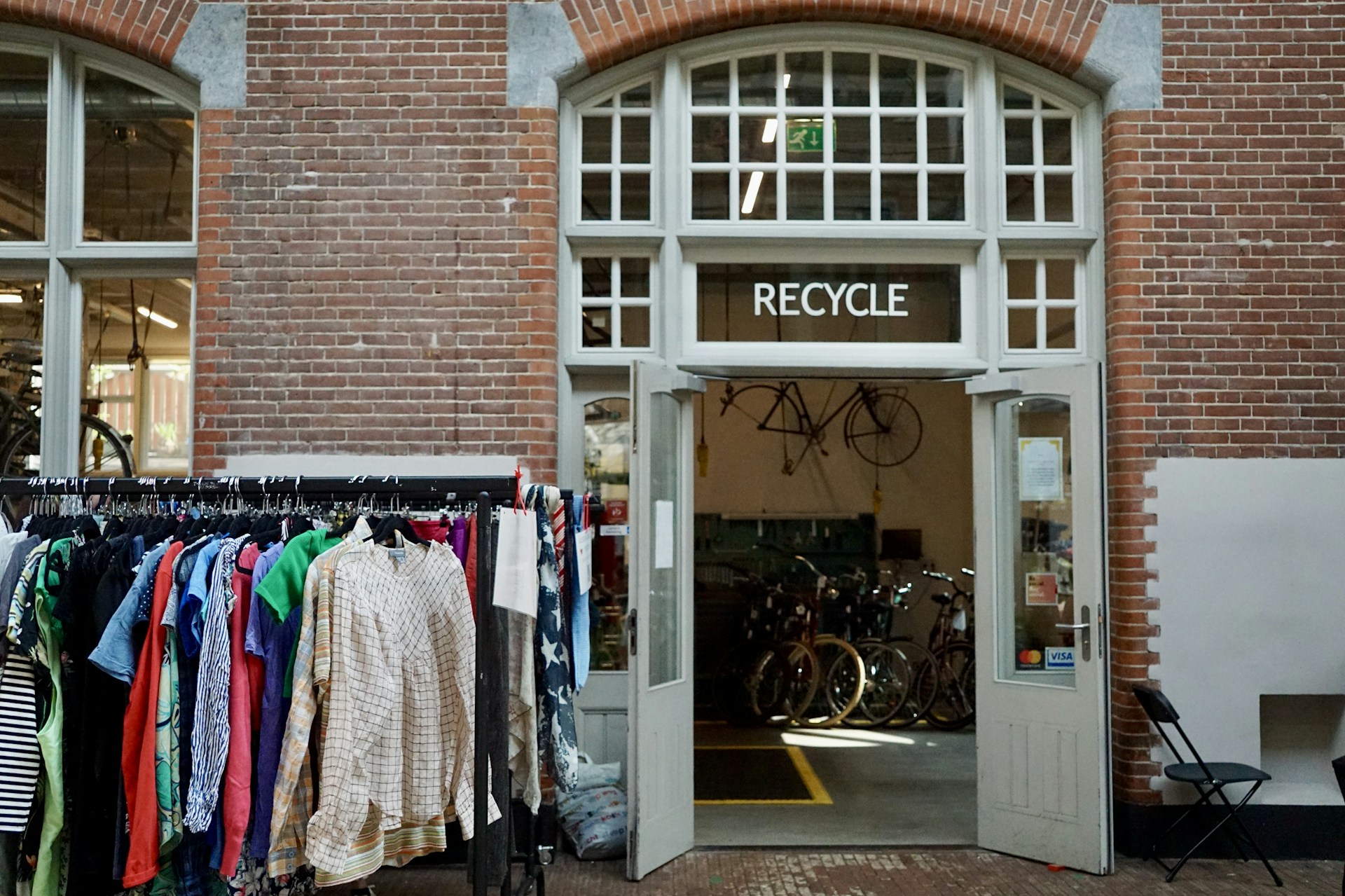 Recycle center with clothes and bicycles inside.
