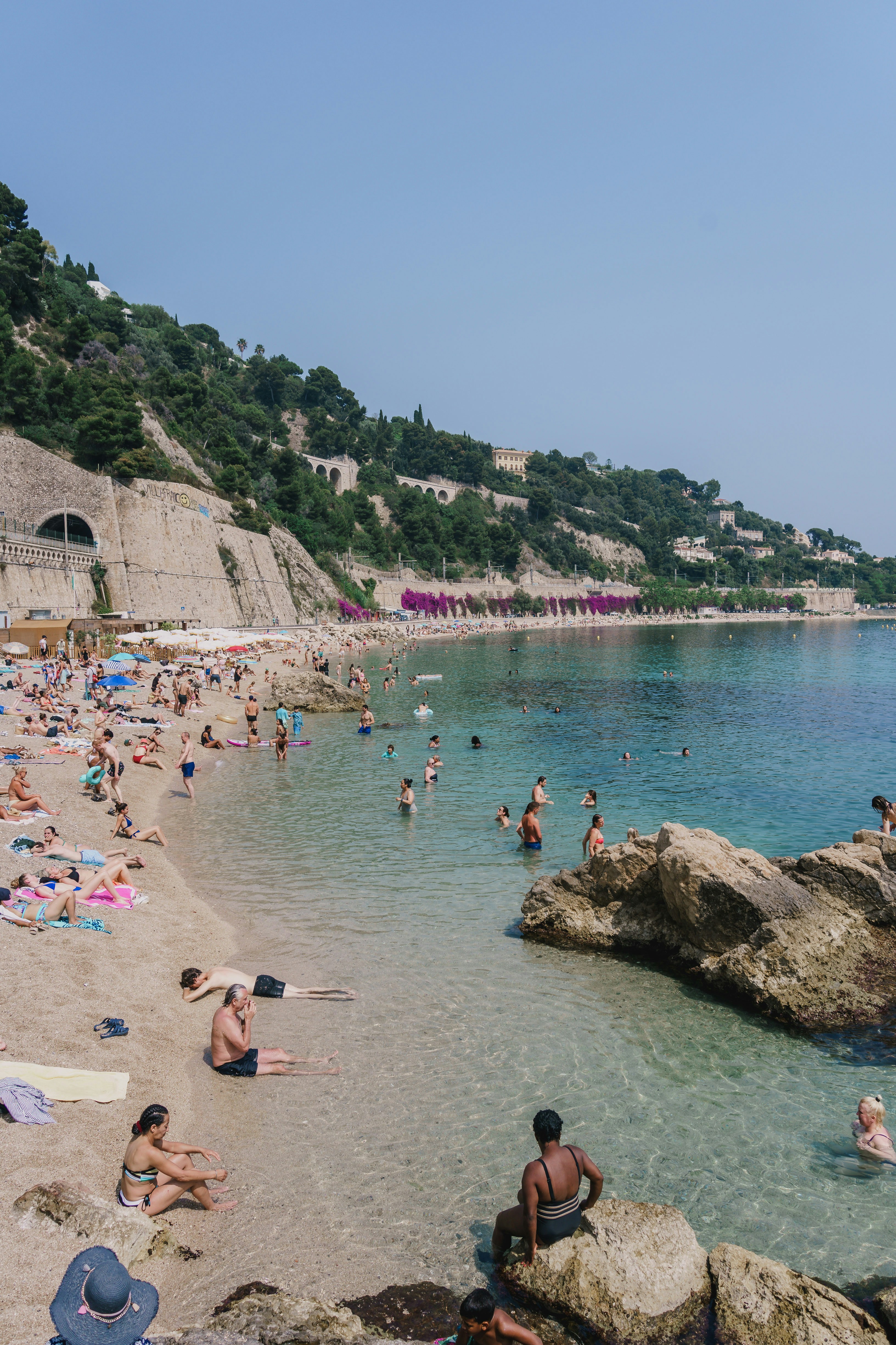 People enjoy a sunny day at the beach.