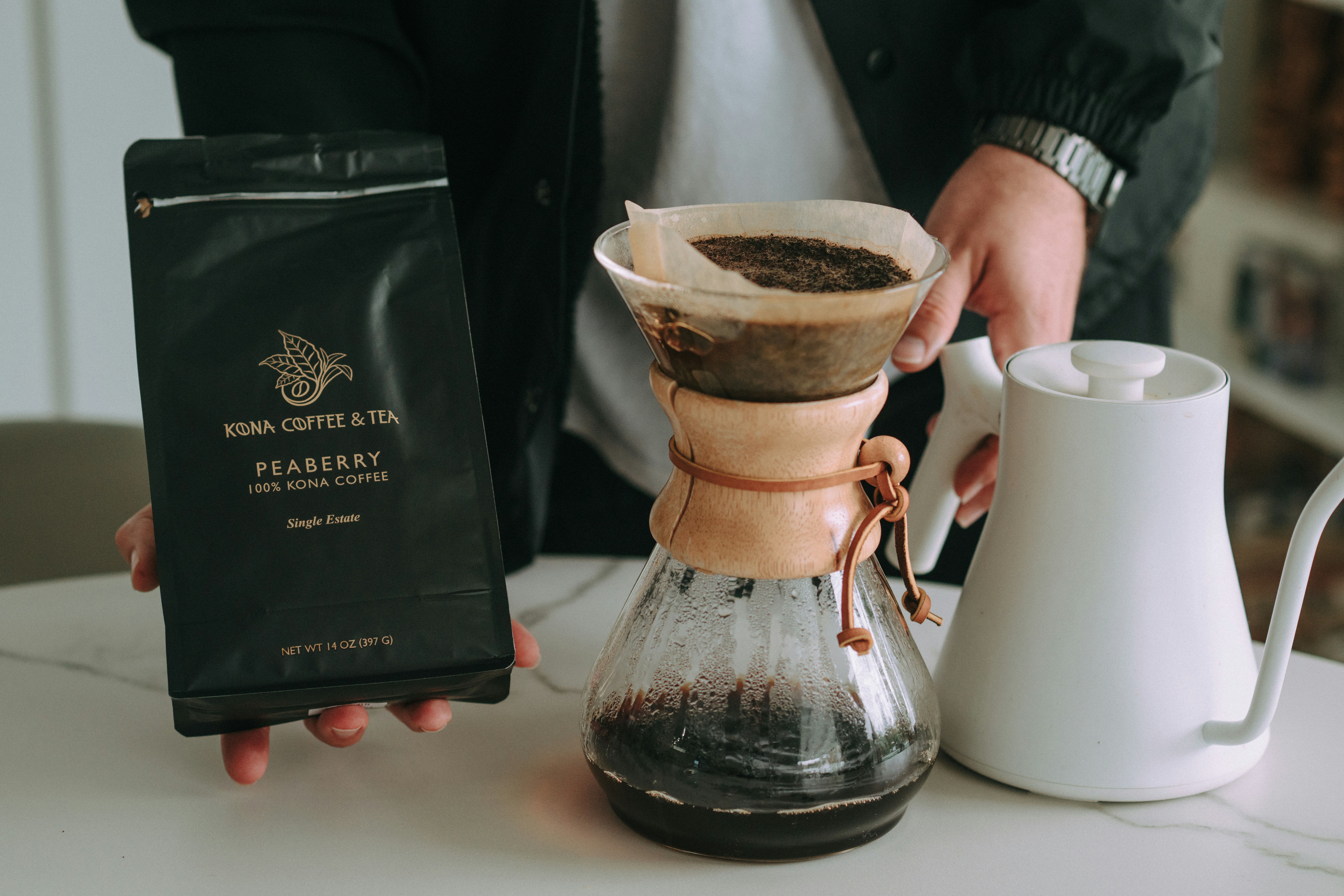 Someone is brewing coffee with a pour-over method.