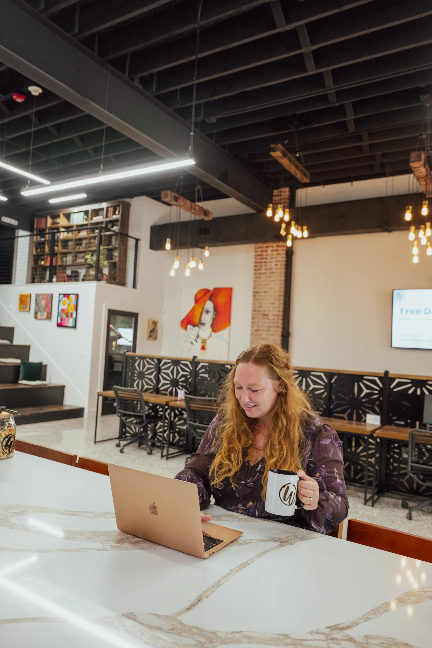 Creator working on a laptop in a stylish workspace
