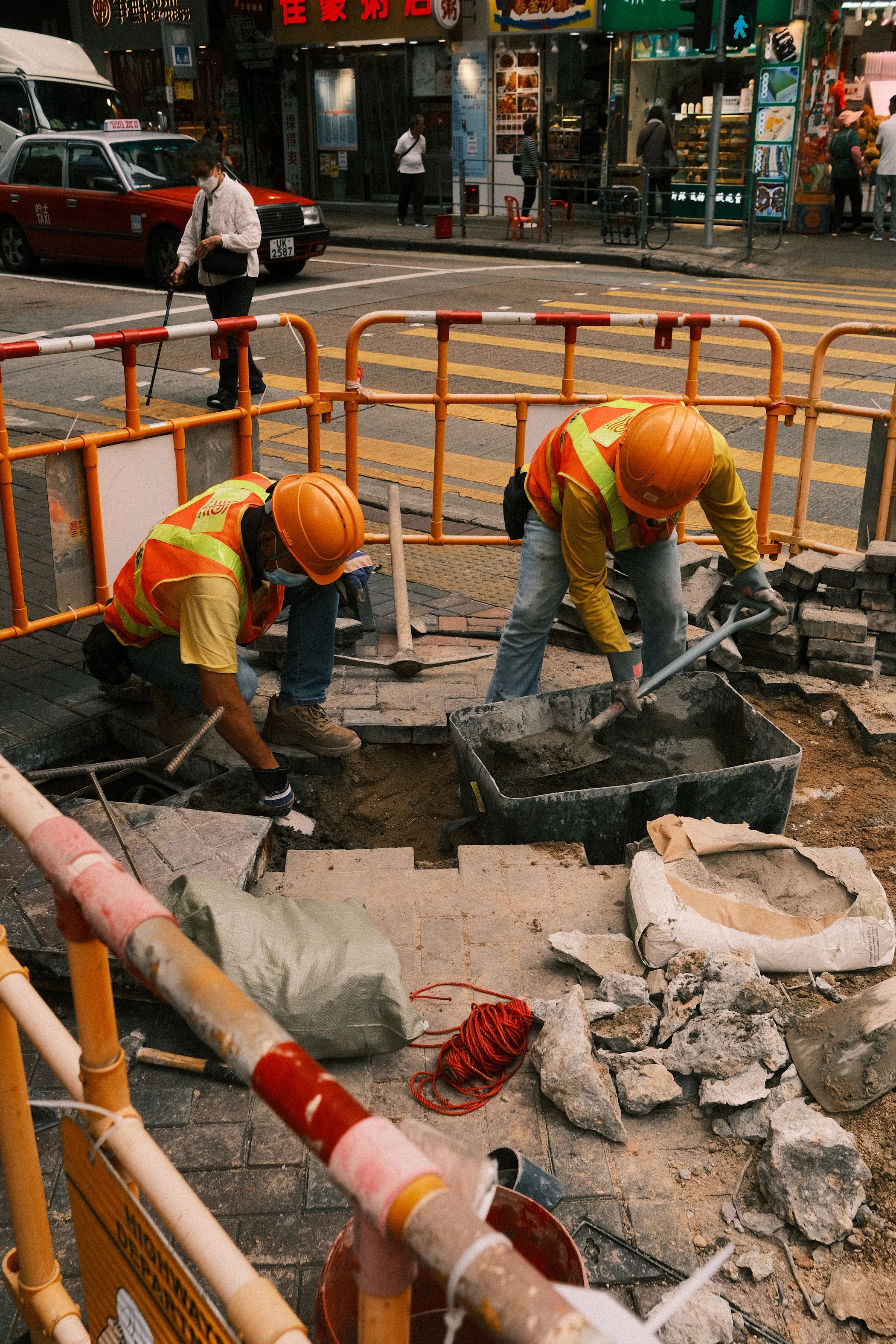 A municipal utility crew repairing underground services beside a public street